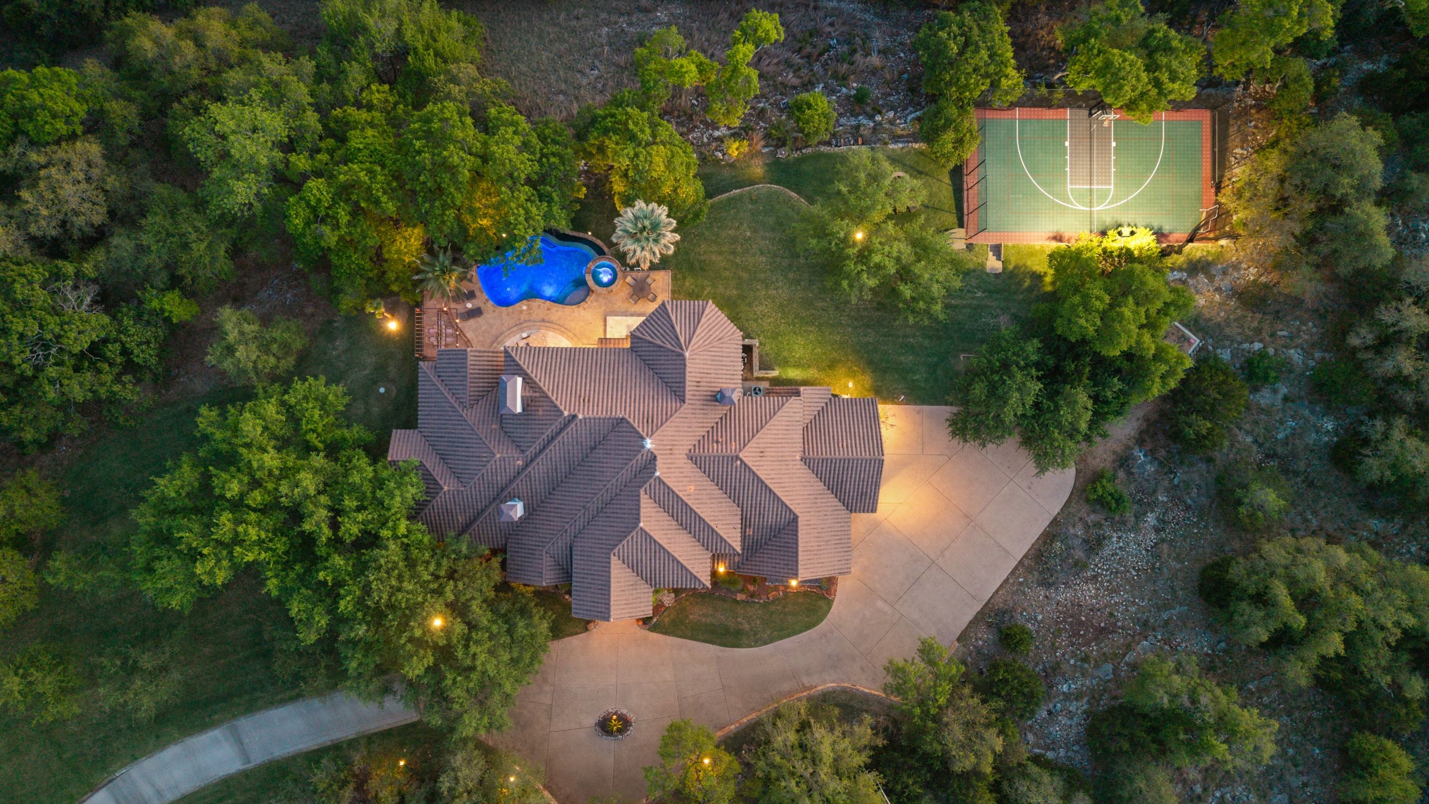 Lakehaven aerial showing the residence, pool, and sport court in Georgetown, Texas